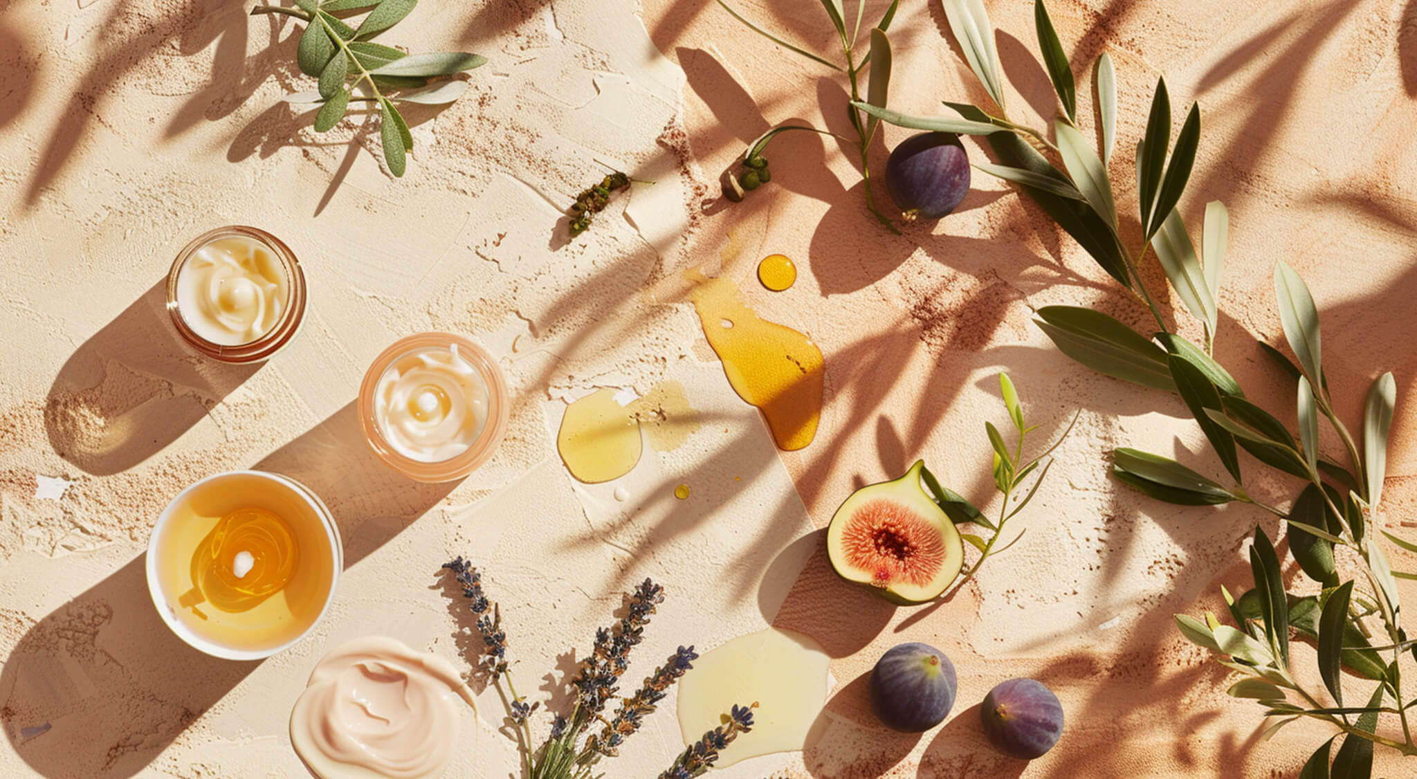 A flat lay image of fresh figs and Mediterranean-inspired products arranged on a light surface, highlighting natural textures and colors