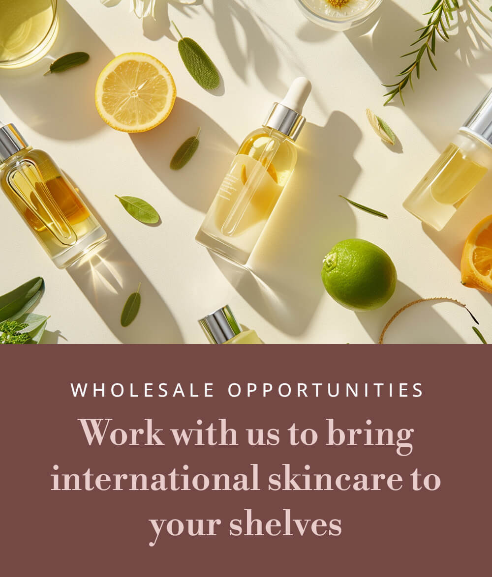 Flat lay of citrus fruits, green leaves, and glass skincare bottles in sunlight, with a blush-pink overlay that reads “Wholesale Opportunities — Work with us to bring international skincare to your shelves.” The image conveys a fresh, Mediterranean-inspired aesthetic for Relterra’s wholesale skincare program.