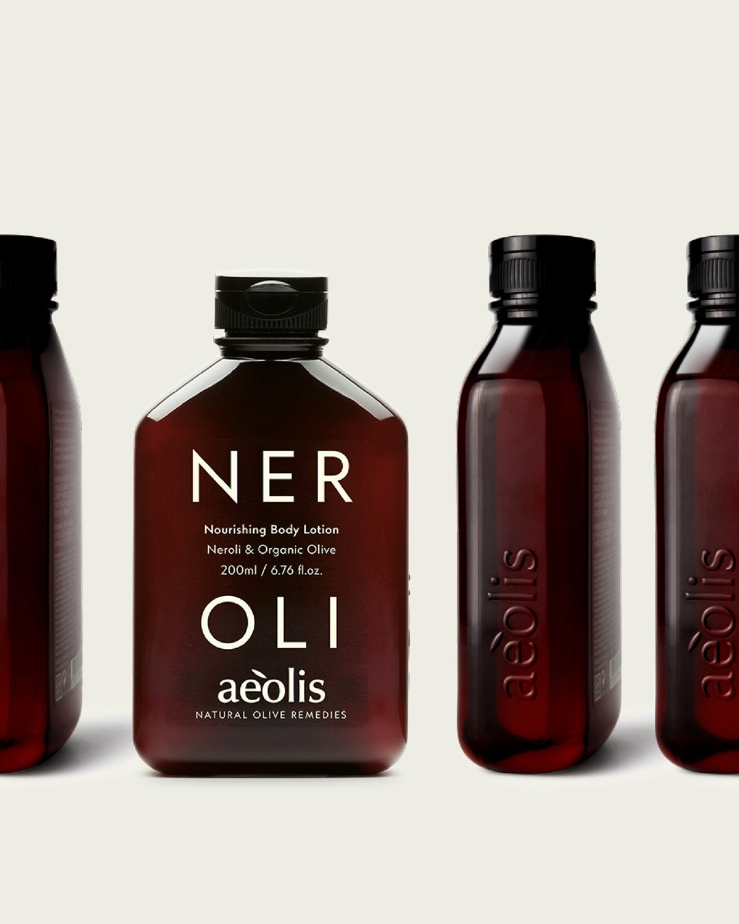 Four bottles of Aeolis Neroli Nourishing Body Lotion on a light beige background