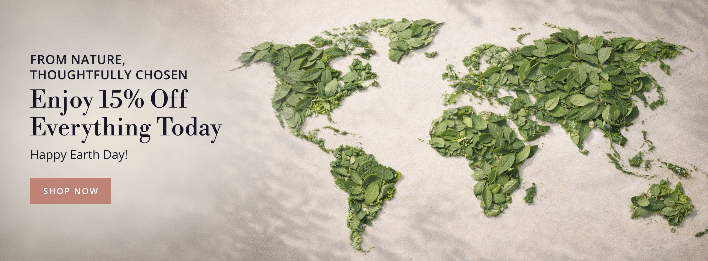 World map made of green leaves with promotional text for 15% Off Sitewide for Earth Day Sale. 