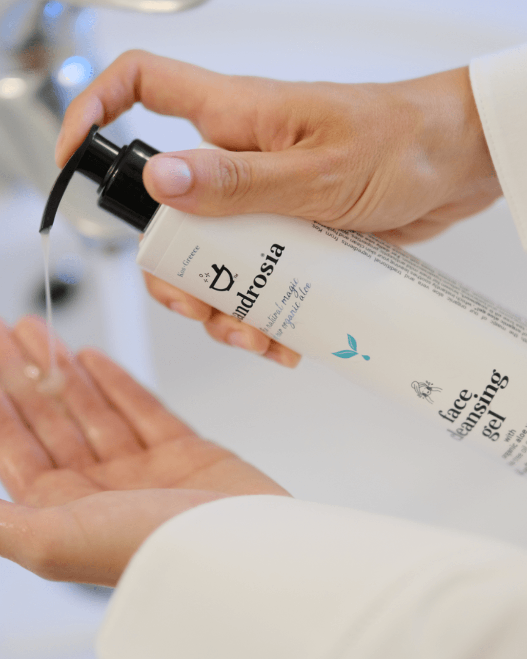 Person holding a bottle of face cleansing gel and pouring it into their hand.