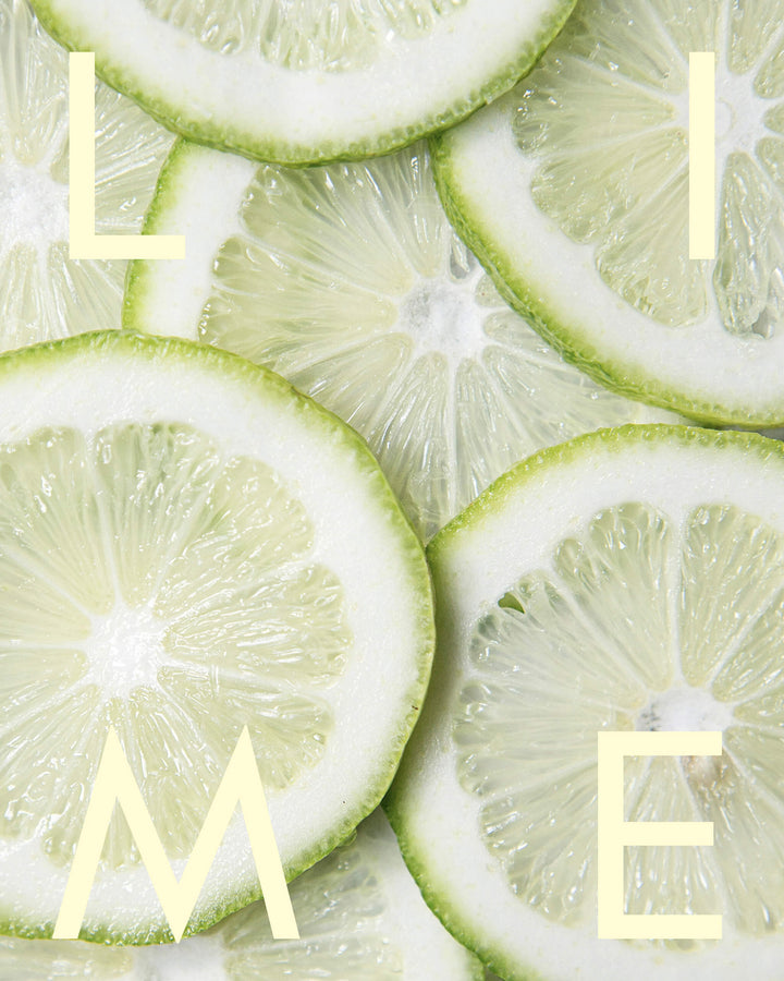 Close-up of sliced limes with the word &